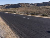 there is a sign in the middle of a desert road to remind someone who's missing