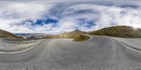 there is a circular panorama of a mountain road and mountains as seen from an angle