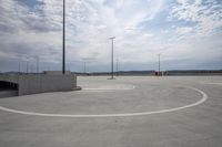 a parking lot with a circular design around the space with street lights on either side