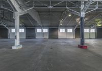 a large empty warehouse with concrete floors and ceilings, with no people walking or sitting