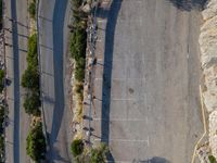 the parking lot is next to a small parking lot near some mountains and buildings with mountains in the background