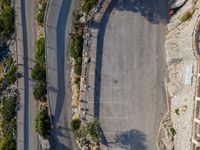 the parking lot is next to a small parking lot near some mountains and buildings with mountains in the background