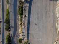 the parking lot is next to a small parking lot near some mountains and buildings with mountains in the background