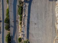 the parking lot is next to a small parking lot near some mountains and buildings with mountains in the background