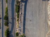 the parking lot is next to a small parking lot near some mountains and buildings with mountains in the background