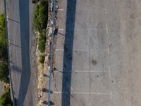 the parking lot is next to a small parking lot near some mountains and buildings with mountains in the background