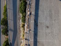 the parking lot is next to a small parking lot near some mountains and buildings with mountains in the background