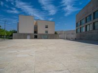 the gray concrete walls of a building have a line of steps on the left side