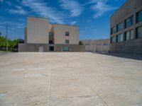 the gray concrete walls of a building have a line of steps on the left side