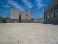 the gray concrete walls of a building have a line of steps on the left side