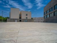 the gray concrete walls of a building have a line of steps on the left side