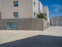 the gray concrete walls of a building have a line of steps on the left side