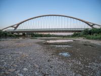 there are two very long bridges that are above the river shore at dusk here, and you can see how close them are