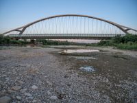 there are two very long bridges that are above the river shore at dusk here, and you can see how close them are