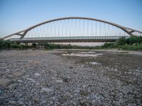 there are two very long bridges that are above the river shore at dusk here, and you can see how close them are