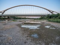 there are two very long bridges that are above the river shore at dusk here, and you can see how close them are