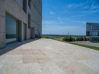 the gray concrete walls of a building have a line of steps on the left side