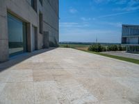 the gray concrete walls of a building have a line of steps on the left side