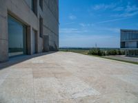 the gray concrete walls of a building have a line of steps on the left side