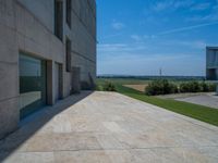 the gray concrete walls of a building have a line of steps on the left side