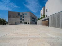 the gray concrete walls of a building have a line of steps on the left side