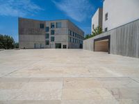 the gray concrete walls of a building have a line of steps on the left side