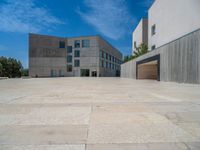 the gray concrete walls of a building have a line of steps on the left side