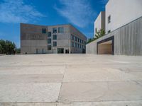 the gray concrete walls of a building have a line of steps on the left side