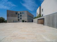 the gray concrete walls of a building have a line of steps on the left side