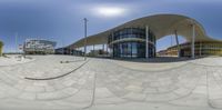 this is a mirror image of an open courtyard with a circular view of buildings in the background