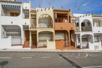 a bunch of tall multileved townhouses in the middle of an open lot