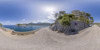 360 - view photograph of an italian road with sea and rocks below it near the coast