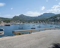 a paved road beside some large boats and a bridge with a bridge to the water