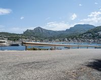 a paved road beside some large boats and a bridge with a bridge to the water