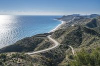 an empty highway winding through the mountains and water on the beach side near cape town, algaridada de gama