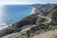 an empty highway winding through the mountains and water on the beach side near cape town, algaridada de gama