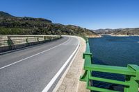 the road passes along the water on a sunny day in europe, where most people can see a boat