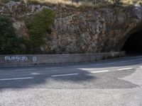 a car going through a tunnel in the middle of a mountain side road with the word pulcetti written on it