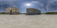 a fish eye view of some buildings on the ground with a ramp and ramp leading to it