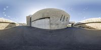 a street view shows a dome building that has a ramp in front of it for pedestrians