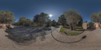 fish eye lens of the road near a building in rural countryside area, looking at a driveway