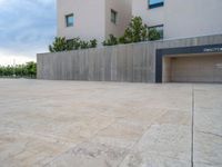 empty area outside concrete building with no people or vehicles at the entrance to area behind it