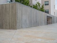empty area outside concrete building with no people or vehicles at the entrance to area behind it