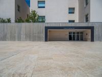 the gray concrete walls of a building have a line of steps on the left side