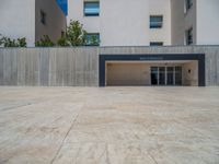 the gray concrete walls of a building have a line of steps on the left side