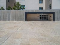 the gray concrete walls of a building have a line of steps on the left side