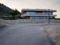 this building is situated on top of a hill next to a paved area where people can walk