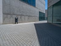 there is a stone wall that reflects the parking area in the window glass at the corner