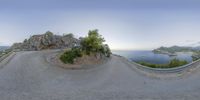 a panorama photo looking like an angle view of a car driving on the road with mountains in the background