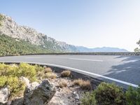 an image of a curved road on the side of the mountain range in croatia at daytime